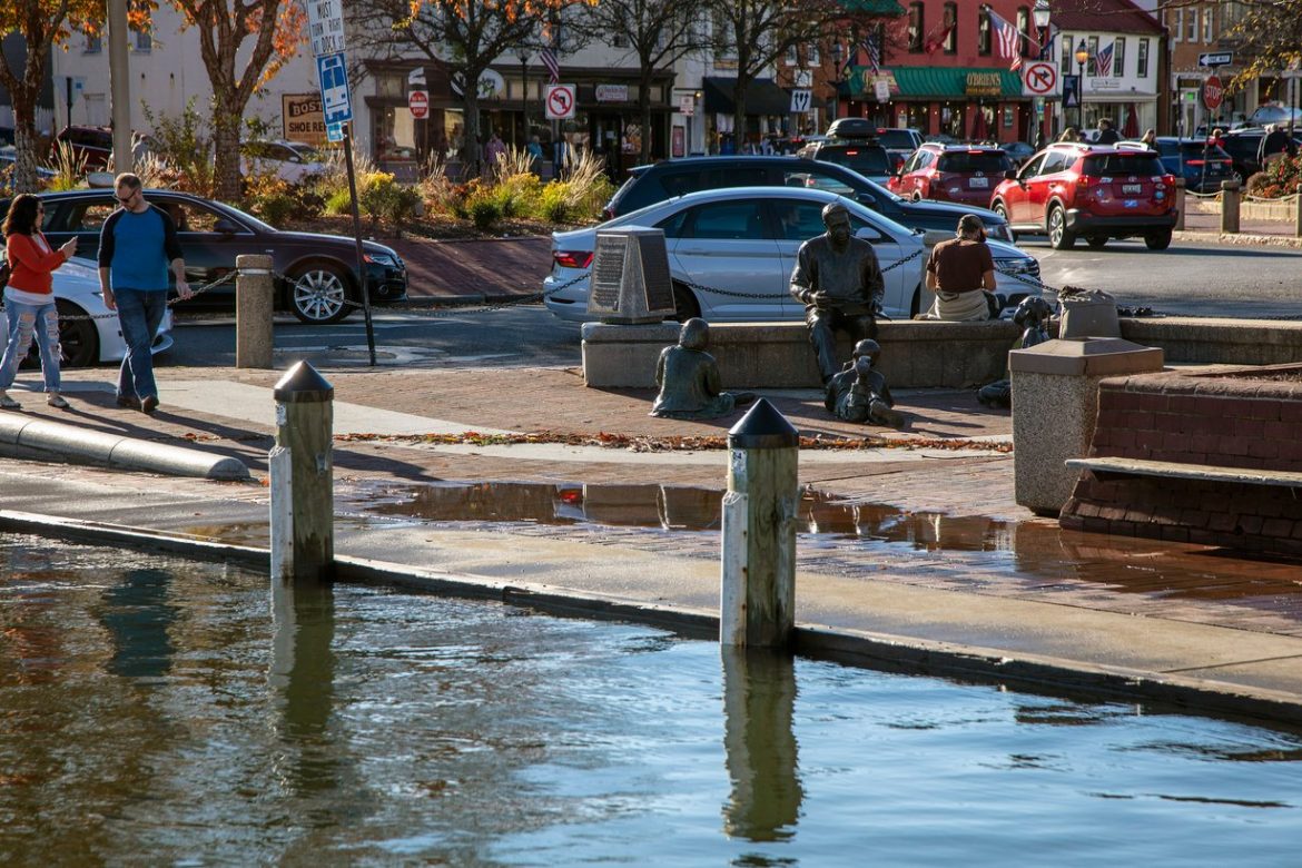 High tide water covers the pavement at the end of Spa Creek in downtown Annapolis, Maryland