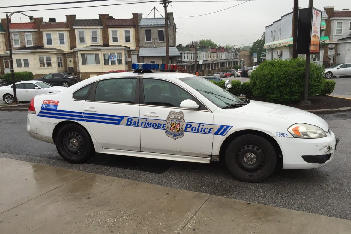 Baltimore City police patrol car stopped at a city intersection