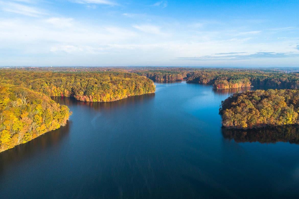 Aerial view of Liberty Reservoir surrounded by autumn forest in Maryland