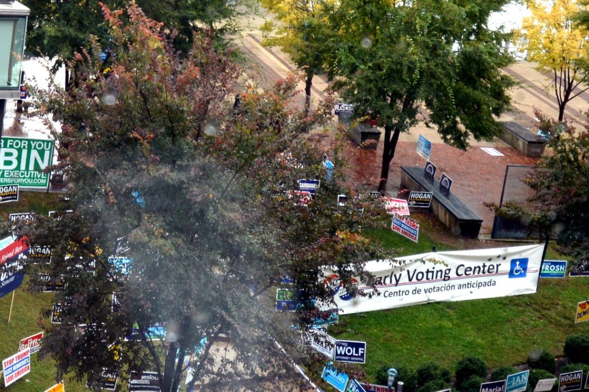 Early Voting Center banner and campaign signs at a Maryland early voting site